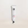 Tube of One Skin sunscreen on a light beige background
