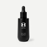 Black dropper bottle with 'ONE SKIN' branding on a beige background