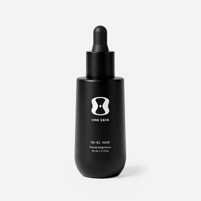 Black dropper bottle with 'ONE SKIN' branding on a beige background