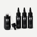 Set of black hair serum bottles with dropper on a light gray background contains descriptive text stating bottle size may vary, the 3 month supply will always come with 150mL of the OS-01 HAIR serum.