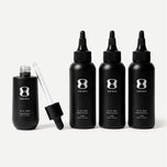 Set of black hair serum bottles with dropper on a light beige background. Contains descriptive text stating Bottle size may vary. The 6-month supply will always come with 150mL of the OS-01 HAIR serum.