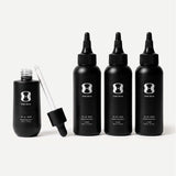 Set of black hair serum bottles with dropper on a light beige background. Contains descriptive text stating Bottle size may vary. The 6-month supply will always come with 150mL of the OS-01 HAIR serum.