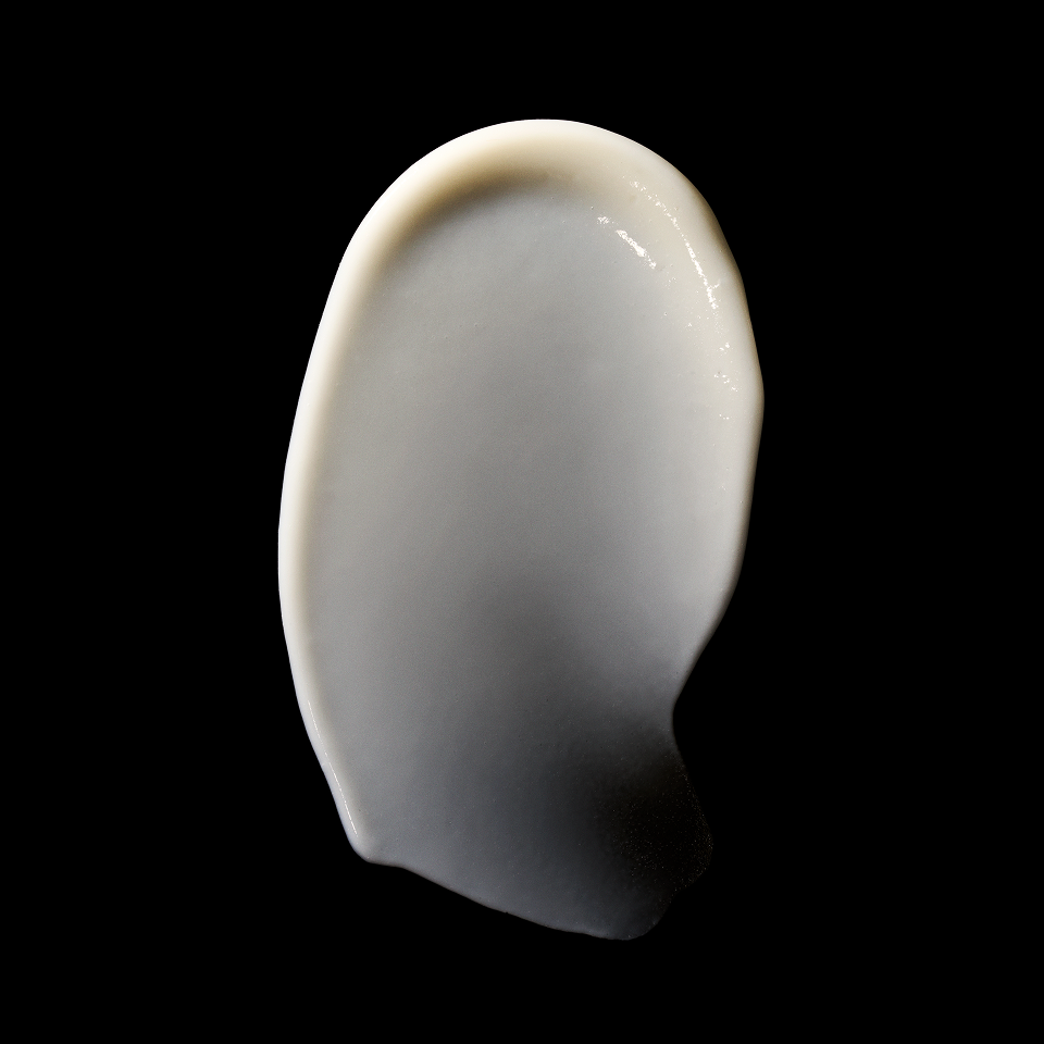 A single irregular, smooth, off-white to light gray solid piece with a glossy surface, centered on a solid black background.
