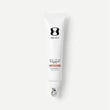 Tube of One Skin sunscreen on a light beige background