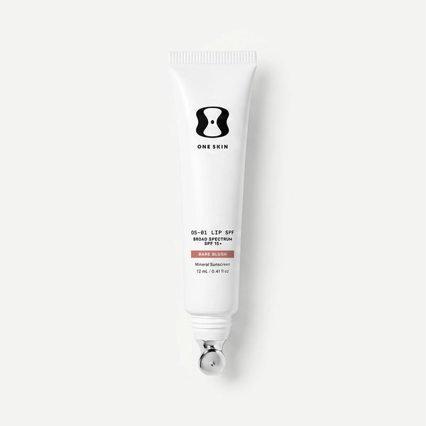 Tube of One Skin sunscreen on a light beige background