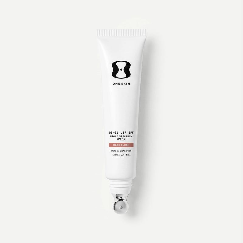 Tube of One Skin sunscreen on a light beige background