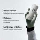 A gloved hand holds a white cylindrical skincare container against a light gray background with promotional text describing barrier support, radiance, and lightweight hydration.