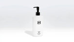 White bottle with black pump on a white background