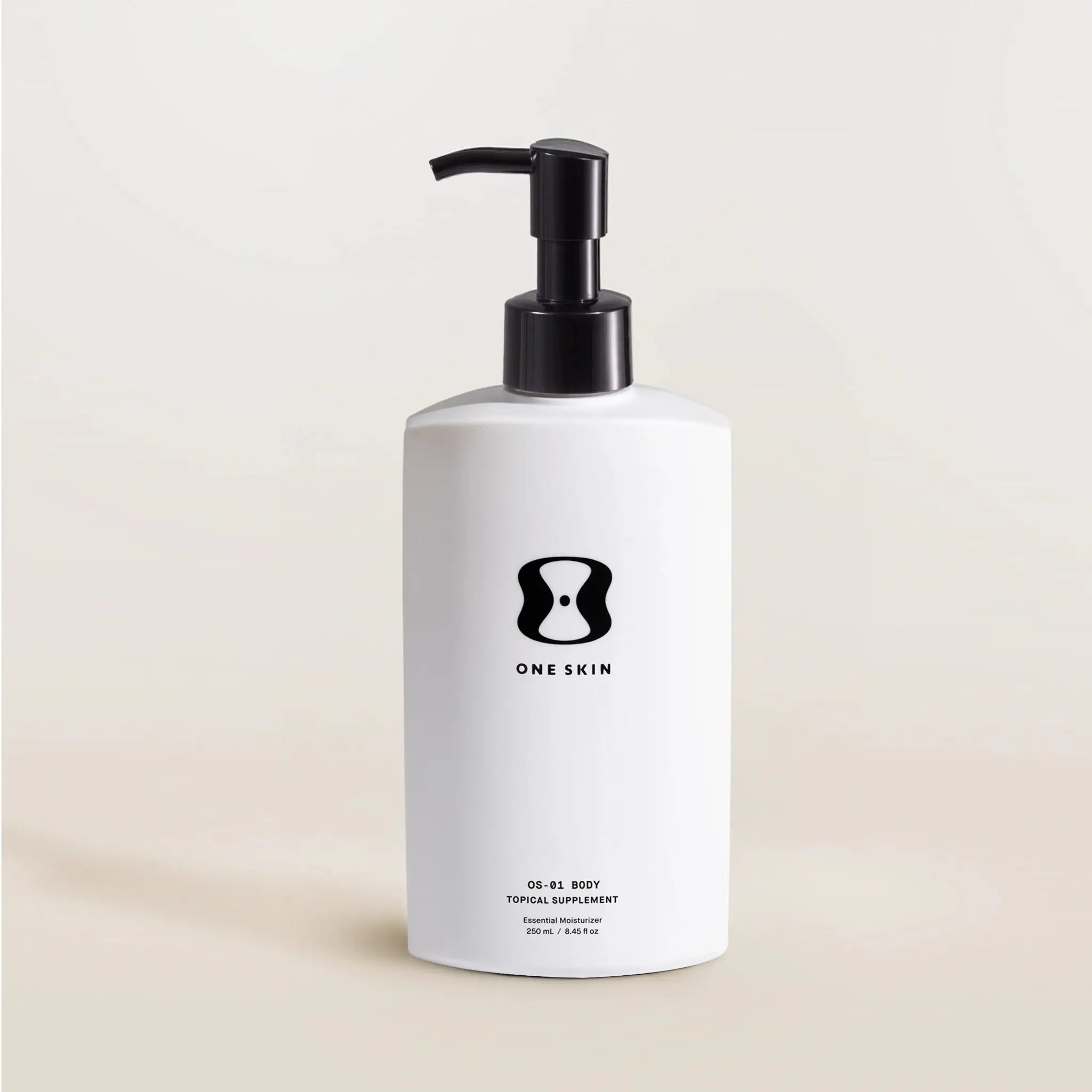 White bottle with black pump and 'One Skin' logo on a beige background