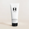 Tube of One Skin body SPF cream on a beige background