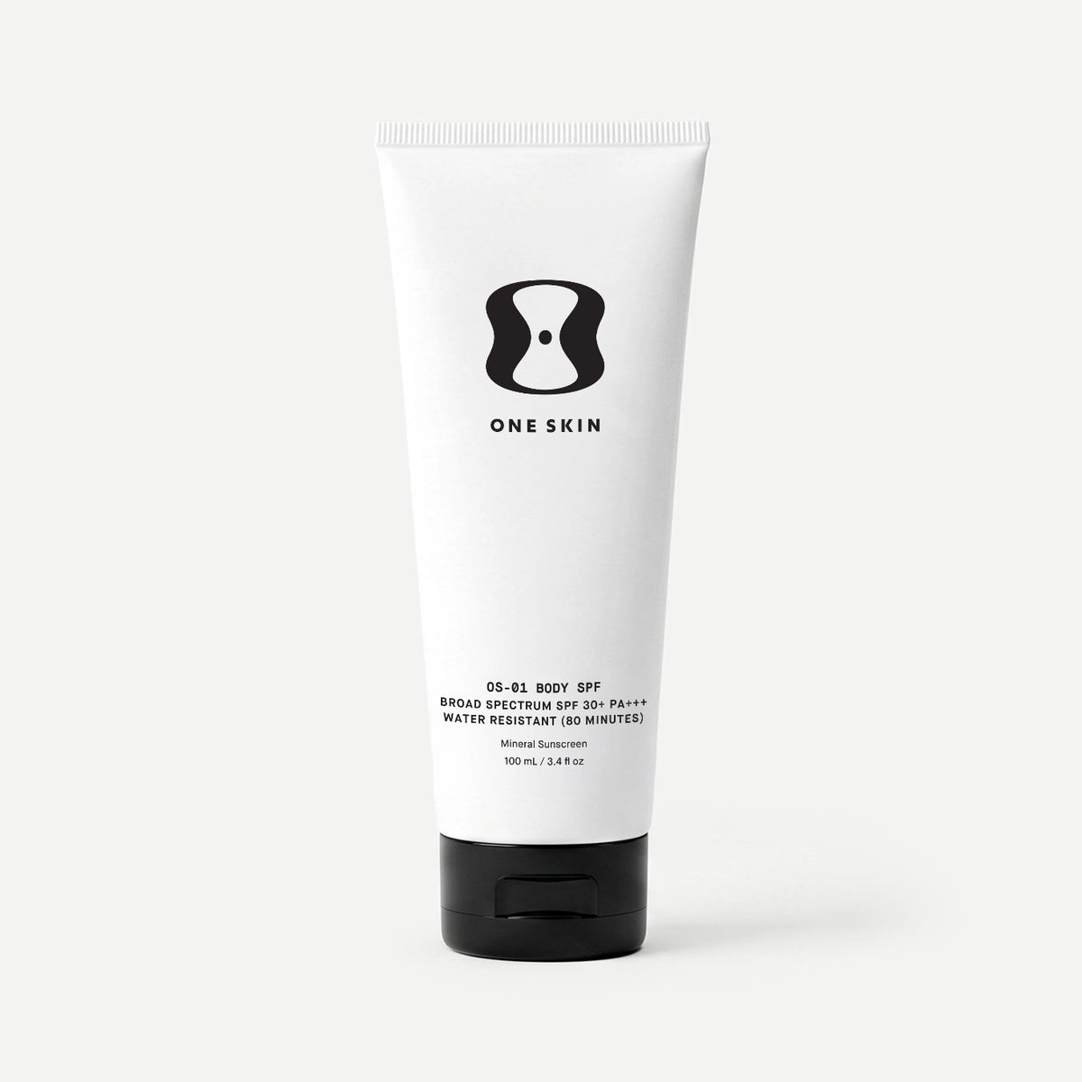 Tube of One Skin body SPF cream on a beige background