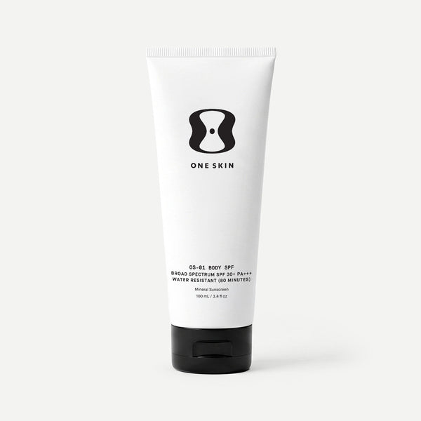 Tube of One Skin body SPF cream on a beige background