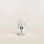 Clear glass supplement bottle with a label on a white background