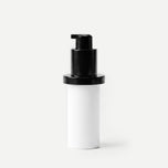 White cylindrical container with a black pump on a beige background