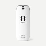 Skincare bottle labeled 'One Skin' on a beige background