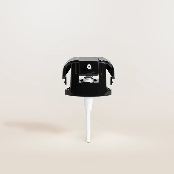 Black and white replacement pump on a beige background
