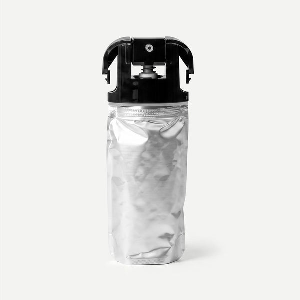 Silver refill package with black cap on a light beige background