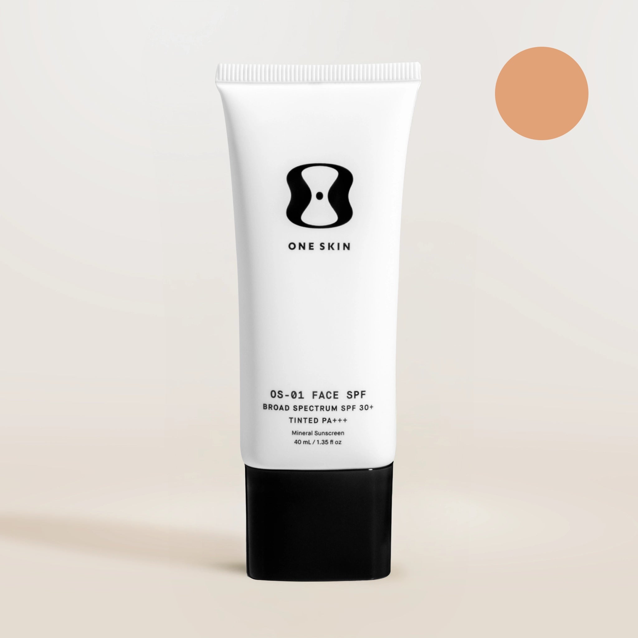 Tube of One Skin sunscreen on a beige background