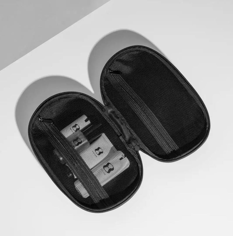 Black carrying case with OneSkin travel products inside on a light gray background