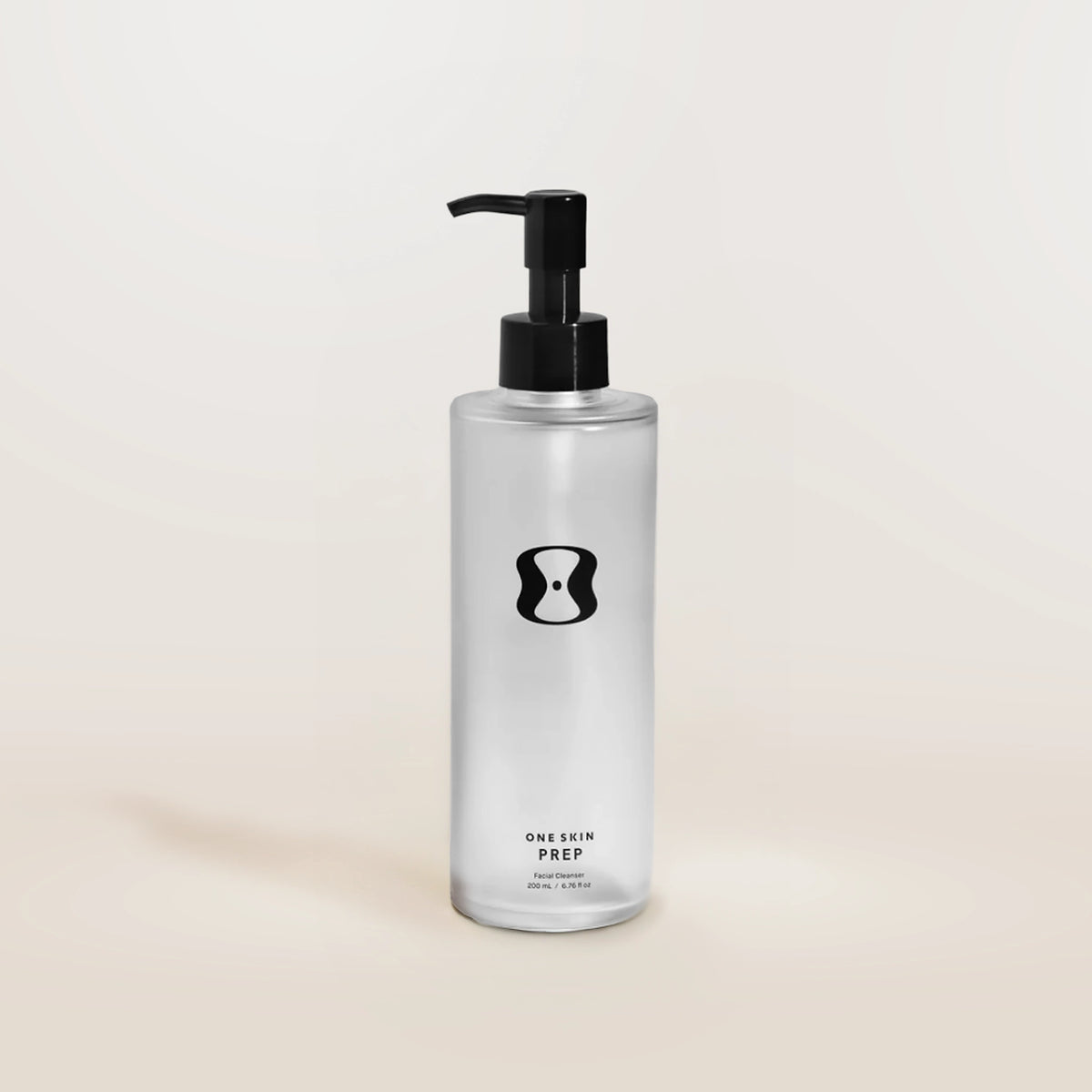 Bottle of 'One Skin Prep' on a beige background