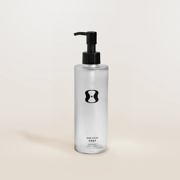 Bottle of 'One Skin Prep' on a beige background