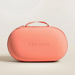 Coral bag with "ONE SKIN" printed on it with a beige background