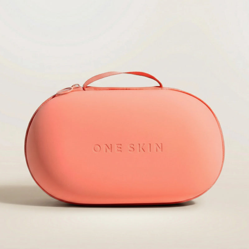 Coral bag with "ONE SKIN" printed on it with a beige background