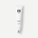 White tube of One Skin lip spf on a light beige background