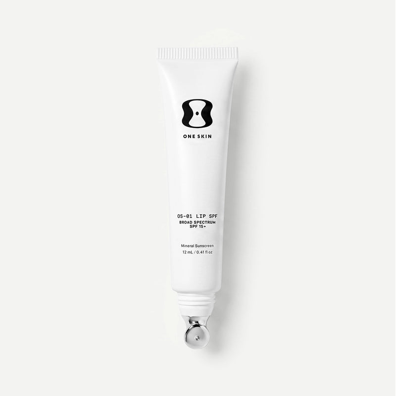 White tube of One Skin lip spf on a light beige background