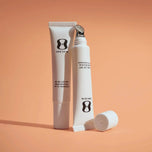 Two skincare products with 'ONE SKIN' branding on an orange background